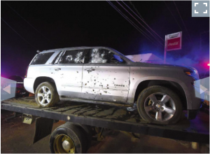 SUV with bullet holes caught in crossfire during operation