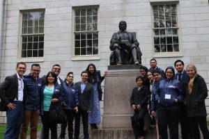 OASIS Boston participants next to a statue of John Harvard, one of the Founders of Harvard College